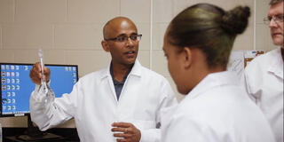 Dr. Sakthi Kumaran in a lab with students