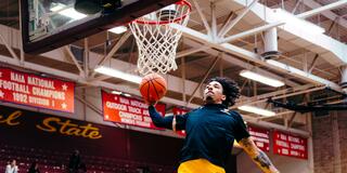 marauder men's basketball player takes a jump shot near the basket during a win over lane college