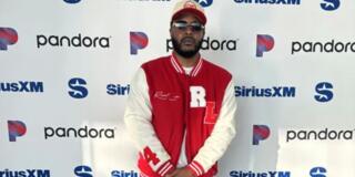 saeed coleman in front of siriuxXM and pandora step and repeat