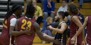 marauder men's volleyball team huddles during game against mount Saint Joseph University