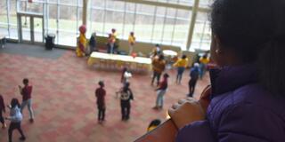 a fifth grader watches marauders dance from the upper level into the lower level of the central state university student center