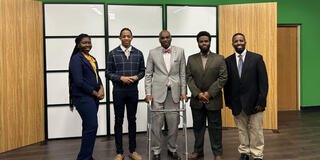 five people including students, president kuti and stanley jefferson pose for a photo in the television studio at central state university