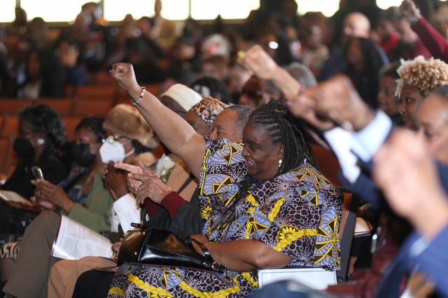 charter day attendees raise their fists in the air while exclaiming, "For God, For Central, For State!"