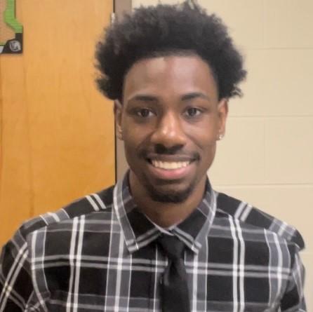 Chi'Kae Hall, a Nationwide intern and student at Central State University, wears a big smile and a flannel-style button-down shirt and tie