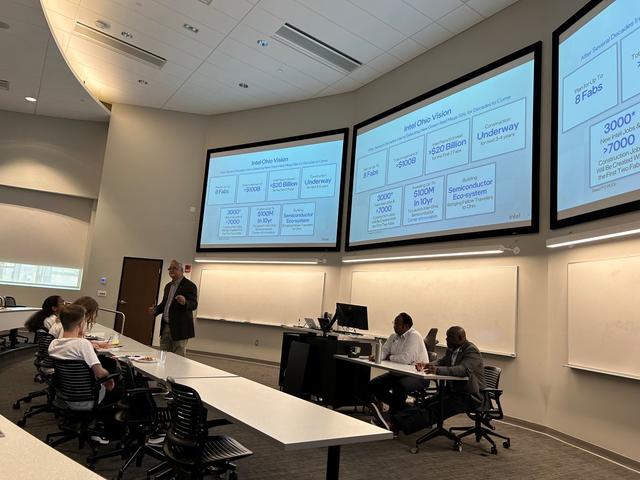 roundtable discussion for Intel students in a lecture hall with large, flatscreen TVs