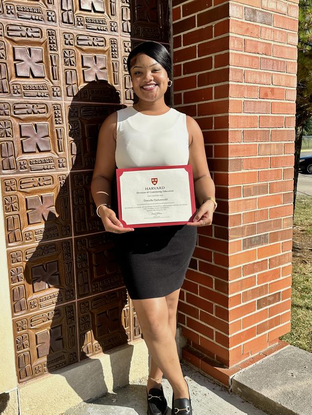 Danielle Darkenwald holding her certificate from Harvard University Division of Continuing Education Leadership Workshops at Central State University
