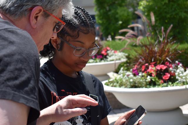 a central state university student works with a professor in an apple camp learning how to create mobile applications