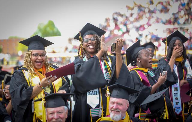 students react to the announcement of a donation clearing their institutional debt