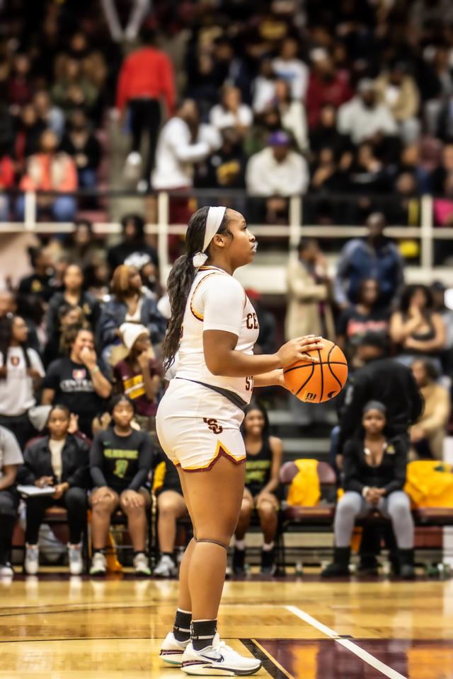 a women's basketball player at the foul line