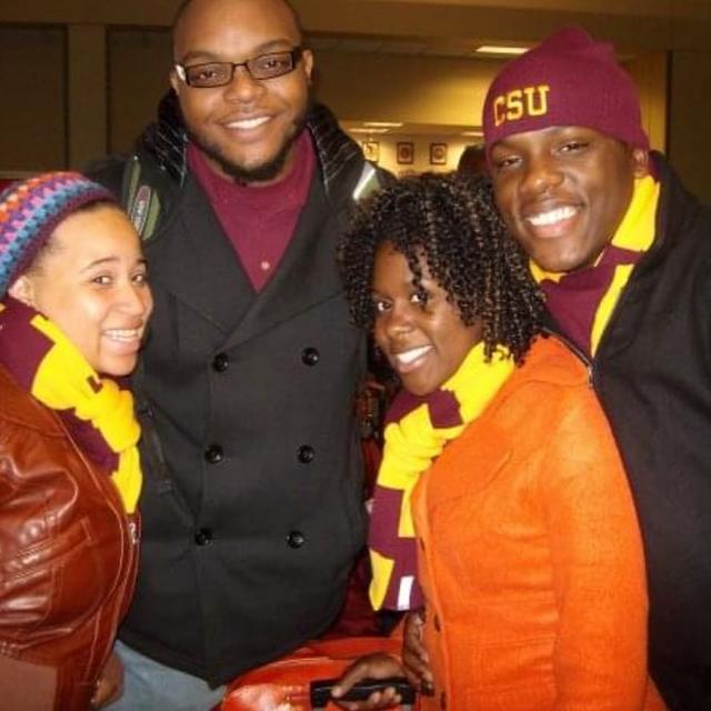 four central state university students in maroon and gold attire