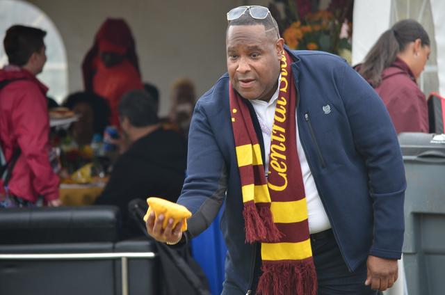 a central state university graduate plays cornhole at homecoming