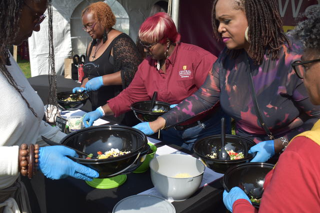 Visiting alumnae join CSU Extension's Sha'Chanda Webster-Davis (second from left), administrative program assistant, in making their do-it-yourself fresh salad at Homecoming Saturday