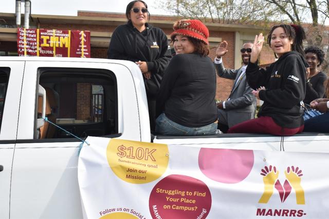 Members of the Central State University chapter of MANRRS (Minorities in Agriculture, Natural Resources, and Related Sciences) ride on a float during the Homecoming parade