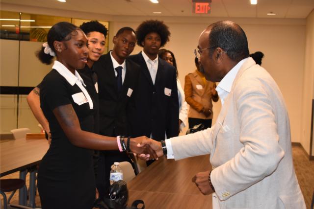 Ohio Sen. Hearcel F. Craig shakes hands with central state university students at the ohio statehouse