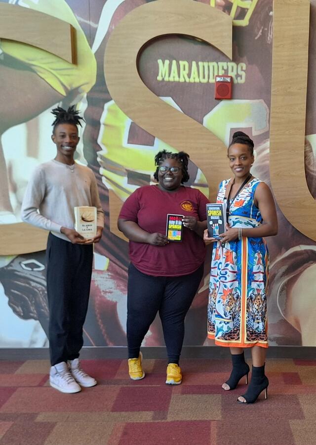 Dana Wright and Amanda Clay pose with Dr. Clark after attending an informational session about her new summer class, U.S. Central Americans in Movement