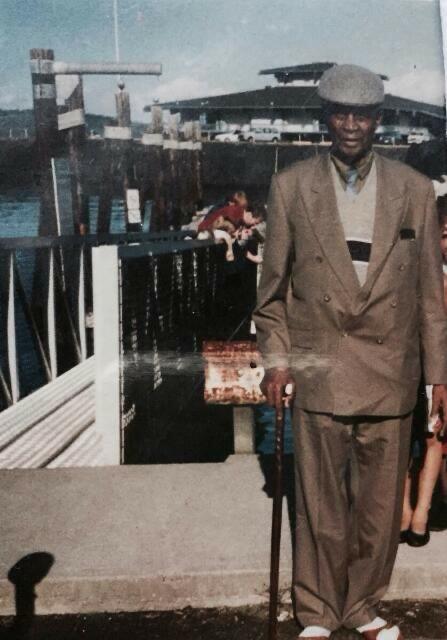 a kenyan man stands near a port