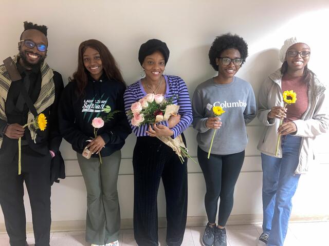 tiffanie clark with four students all holding flowers