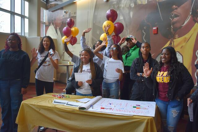 pirate ambassadors cheering in the university student center