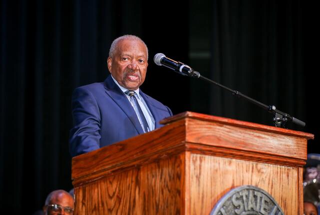 dr. jesse w. gardner speaking into microphone at podium at central state university