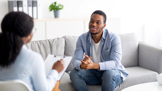 a young African American college student consults with a doctor